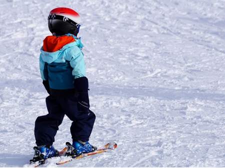 boy on snow with skis